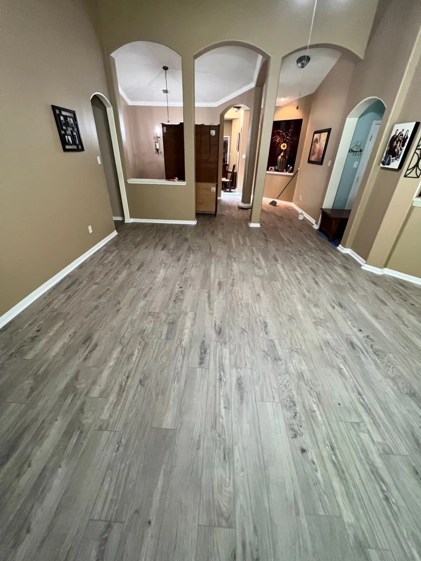 Wide-plank classic gray LVP through an open-plan entry and hallway