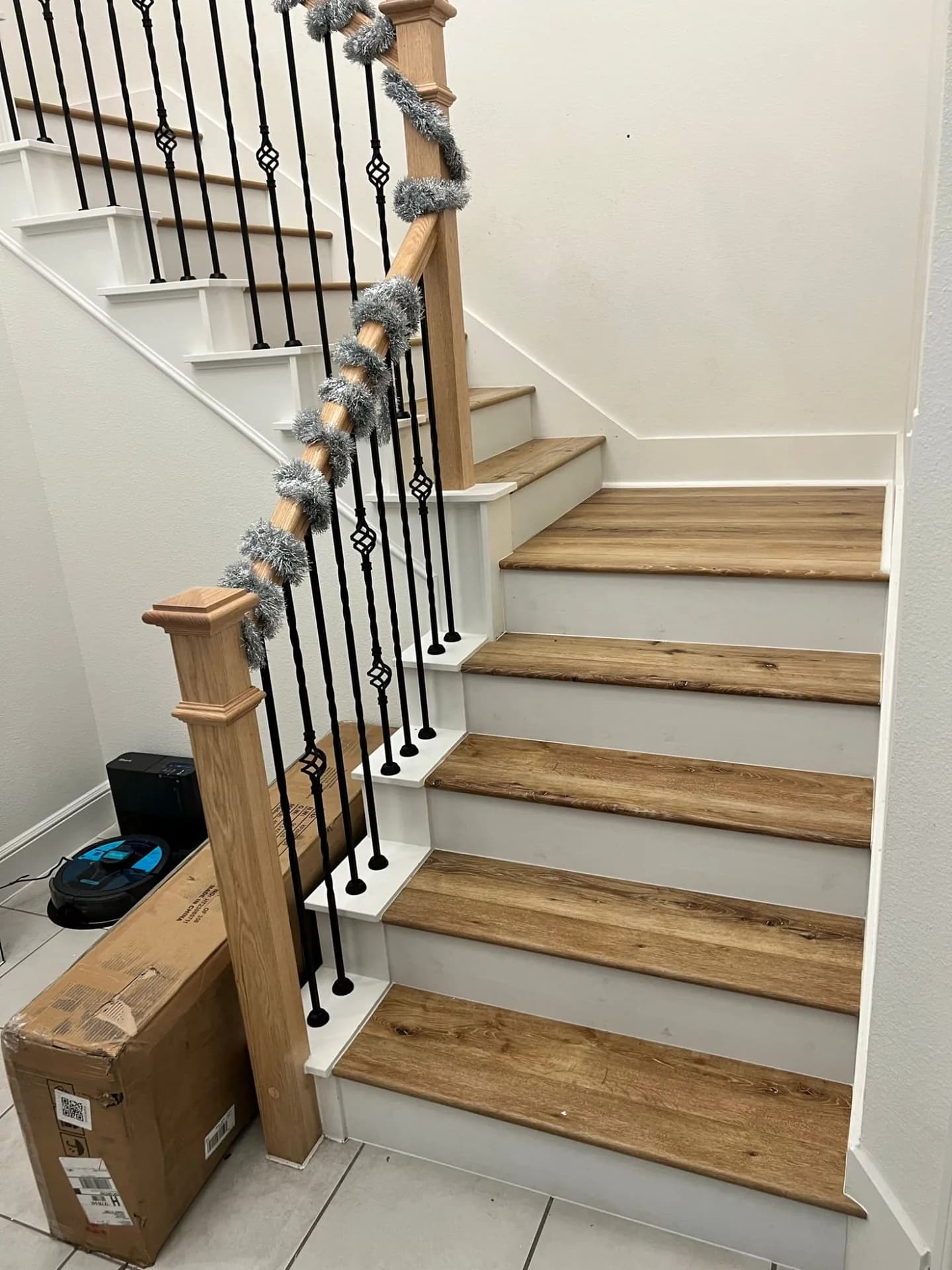 A staircase clad in rustic oak LVP, seen from the landing